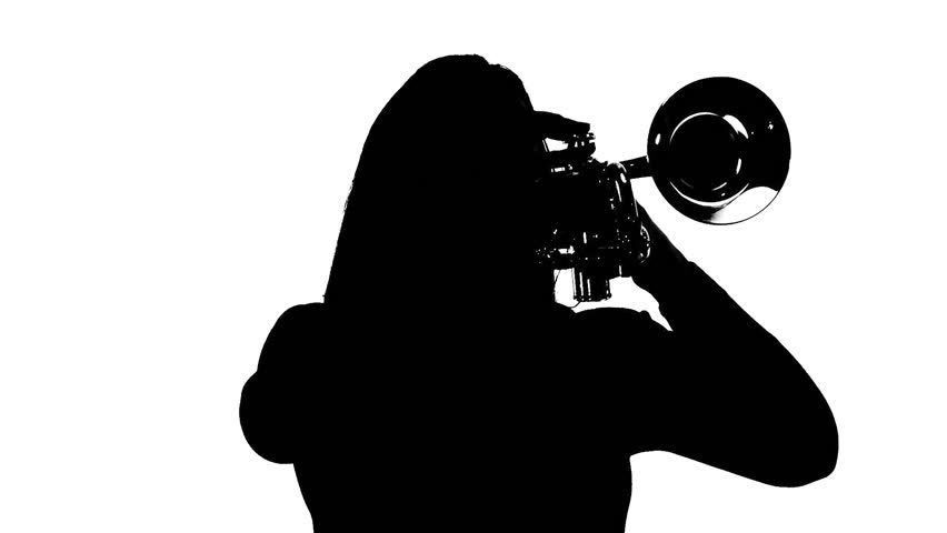 Young woman plays the trumpet in a studio. Black and white silhouette,