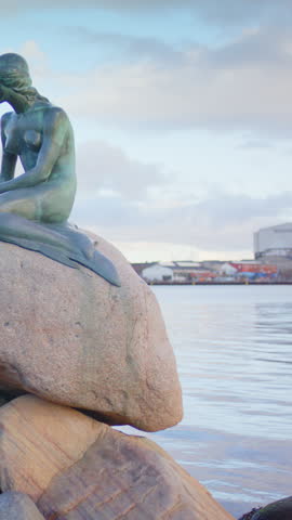 Copenhagen , Denmark - 02 07 2024: Slider shot of The Little Mermaid sculpture next to Langelinie pier