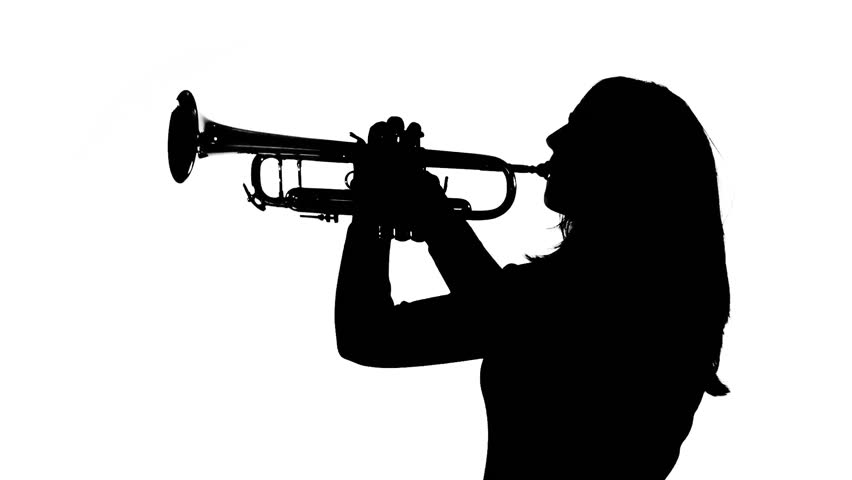 Young woman plays the trumpet in a studio. Black and white silhouette, profile