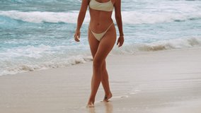 beautiful girl in bikini walking along the beach shoreline - Powered by Shutterstock - Get 15% off with code: PIKWIZARD15