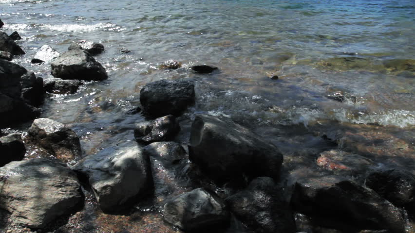 Tilt up from Jenny Lake, looking across to the mountains looking across Jackson Lake in Grand Teton National Park, Wyoming.