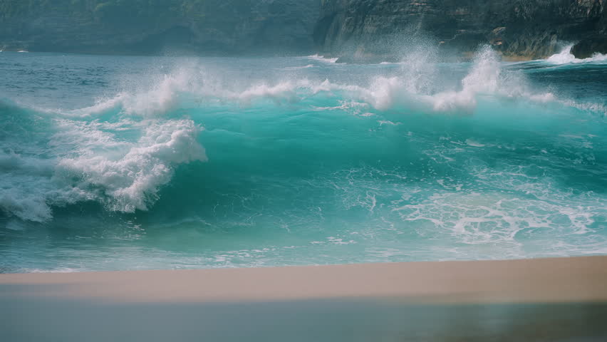 Powerful turquoise wave crashing on Kelingking Beach slow motion