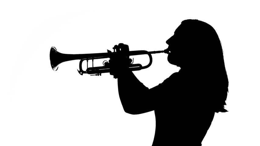 Young woman plays the trumpet in a studio. Black and white silhouette,