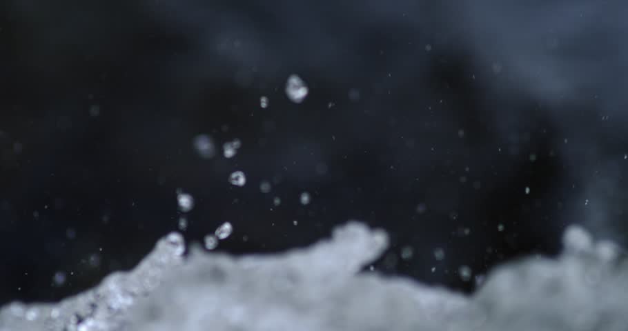 Slow motion close-up footage of turbulent river rapids.