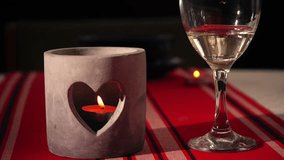 Heart shape romantic candle holder with glass of wine close up 4k shot selective focus - Powered by Shutterstock - Get 15% off with code: PIKWIZARD15