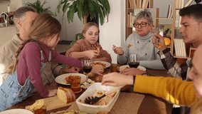 Grandparents, parents, and grandchildren gather around a dining table, sharing a delicious meal and creating lasting memories in a warm and inviting home setting - Powered by Shutterstock - Get 15% off with code: PIKWIZARD15
