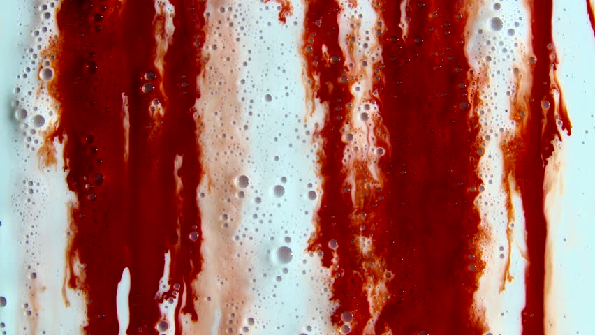 Gorey blood flowing across a foam liquid surface.
