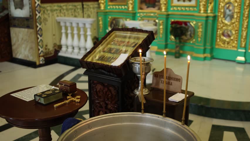 baptismal font with candles on it in an Orthodox church