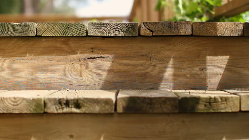 Detail of wooden step and deck planks, with dolly move from right to left.