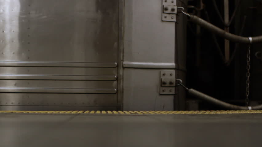 Close detail of a subway train departing from platform in Manhattan, New York.