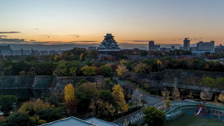 Osaka Japan time lapse city skyline sunrise at Osaka Castle in autumn season