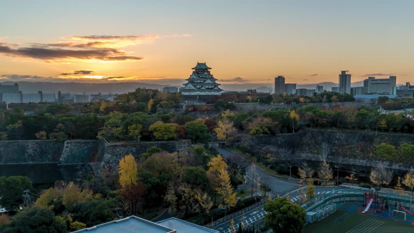 Osaka Japan time lapse city skyline sunrise at Osaka Castle in autumn season