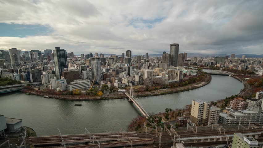 Osaka Japan time lapse city skyline at Okawa River and Kawasaki Bridge
