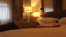 The man falls on the bed, tired from the journey. Slow motion, travel background - Powered by Shutterstock - Get 15% off with code: PIKWIZARD15