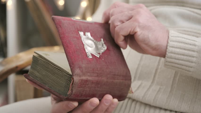male hands leafing through pages of an old photo album, black and white photographs, evoking nostalgia and cherished memories past, family history and forgotten moments, genealogy archive