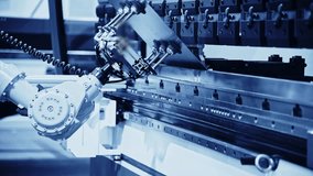 Pick and place industrial robotic arm manipulator moving sheet metal: part of hydraulic press bending machine - Powered by Shutterstock - Get 15% off with code: PIKWIZARD15
