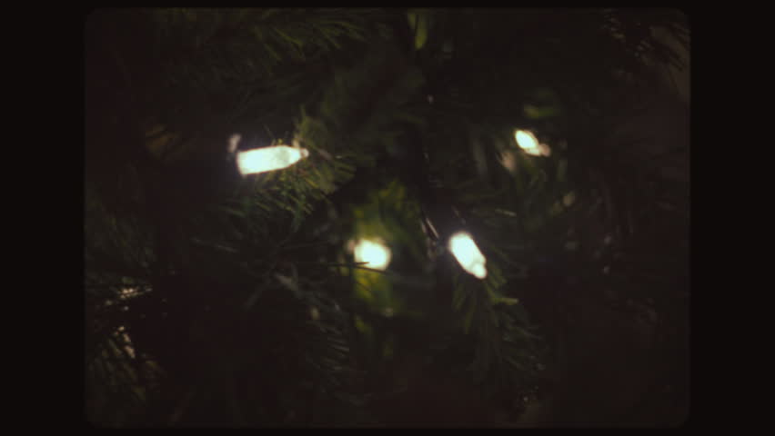 Close up of warm garland lights on a Christmas tree. Vintage Look.