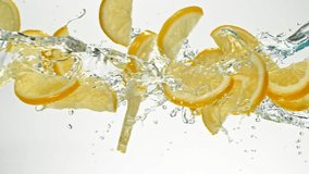 Super Slow Motion of Flying Lime Slices in Water Splashes, White Background. Filmed on High Speed Cinema Camera, 1000 fps. Speed Ramp Effect. - Powered by Shutterstock - Get 15% off with code: PIKWIZARD15