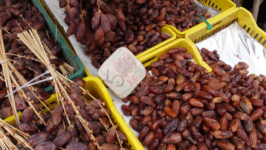 Price tag for bundles of dates at market stall in Tunis, inflation and high prices in Tunisia
