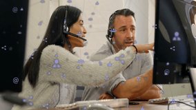 Discussing work, two colleagues wearing headsets with animation of social media icons. Teamwork, communication, technology, collaboration, virtual meeting, digital - Powered by Shutterstock - Get 15% off with code: PIKWIZARD15