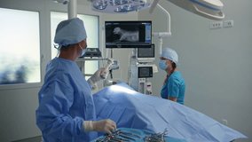 Two veterinary healthcare professionals, a vet doctor, and a technician during pet surgery in an operating room at a clinic, medium shot. - Powered by Shutterstock - Get 15% off with code: PIKWIZARD15