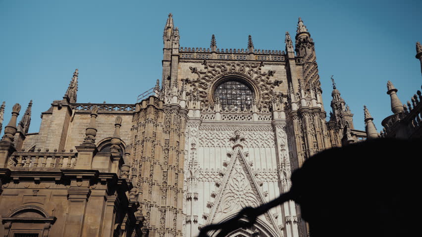 The façade of the Giralda tower, with its intricate Moorish arches and ornate brickwork, stands as a stunning testament to Seville’s rich architectural history.