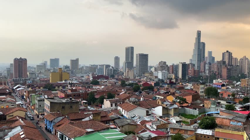 Aerial view of La Candelaria neighborhood backgrounded by the high buildings of downtown Bogota, capital of Colombia.