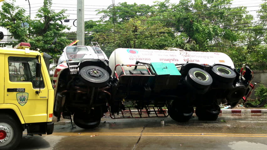BANGKOK - APRIL 15: A rolled-over gas truck is being craned back on wheel in
