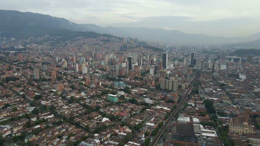 Aerial view of Medellin city center with scenic mountain landscape, residential and office buildings, Colombia.