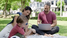 Mixed race little boy enjoy playing and painting while parent taking him to picnic in the park. Father using the laptop, working on the weekend.
 - Powered by Shutterstock - Get 15% off with code: PIKWIZARD15