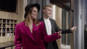 Young man and woman couple dancing in fashion clothes store. Two smiling customer select stylish clothing in fashion store dressing room, offering expert advice and enhancing shopping experience - Powered by Shutterstock - Get 15% off with code: PIKWIZARD15