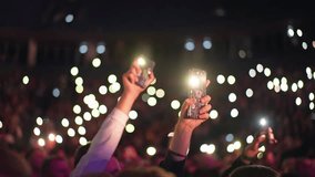 Many fun people lift hand up hold cell phone flash light. Fan crowd wave flashlights. Epic live music concert atmosphere. Big open air k pop arena. Cool night fest. Lot joy men hang out. Kpop chill. - Powered by Shutterstock - Get 15% off with code: PIKWIZARD15