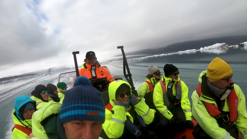 JOKULSARLON, ICELAND – MAY 22, 2019: Tourists having a boat trip in Jokulsarlon lagoon among melting icebergs, Iceland