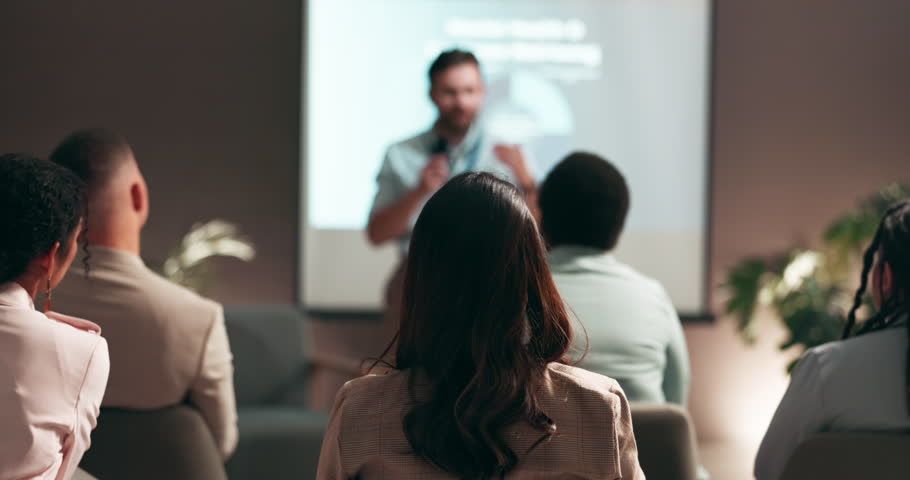 Business people, speaker and presentation with question in audience for interaction, feedback or engagement at office. Group, employees or seminar with hands raised for proposal at speech convention