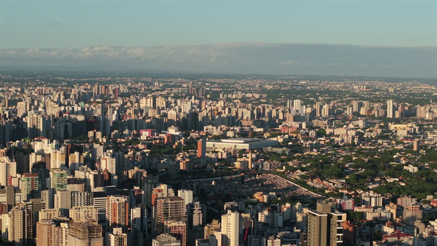 Aerial view of Curitiba, Brazil, with the Ligga Arena (Arena da Baixada) visible in the city skyline.