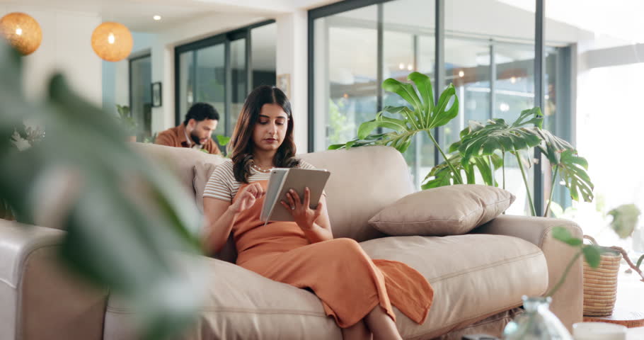 Typing, search and tablet with woman on sofa for social media post, reading or online update. Networking, newsletter subscription and connection with person in living room at home for chat and scroll