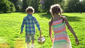 Children joyfully participate in an Easter egg hunt in a sunny park. They gather colorful eggs into a wicker basket and walk barefoot on lush grass, enjoying a cheerful spring celebration. - Powered by Shutterstock - Get 15% off with code: PIKWIZARD15