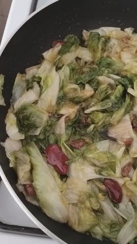 escarole that cooks in a pan in a kitchen