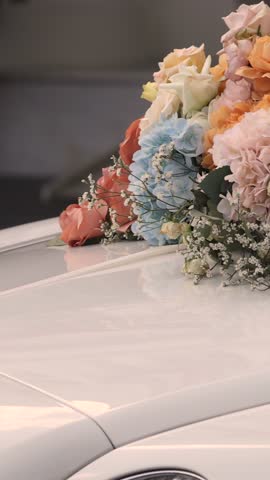 Wedding decor flowers on the car hood.