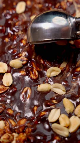 Chocolate peanut dessert with metal spoon. Sweet desserts concept.