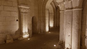 Medieval stone crypt with arched corridors and columns, illuminated with warm lighting - Powered by Shutterstock - Get 15% off with code: PIKWIZARD15
