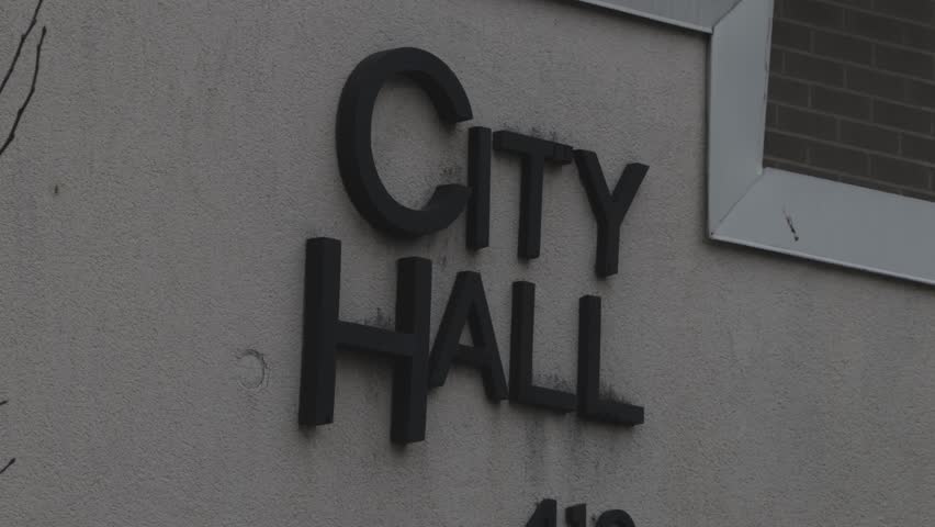 East Lansing, Michigan city hall sign close up with stable video.