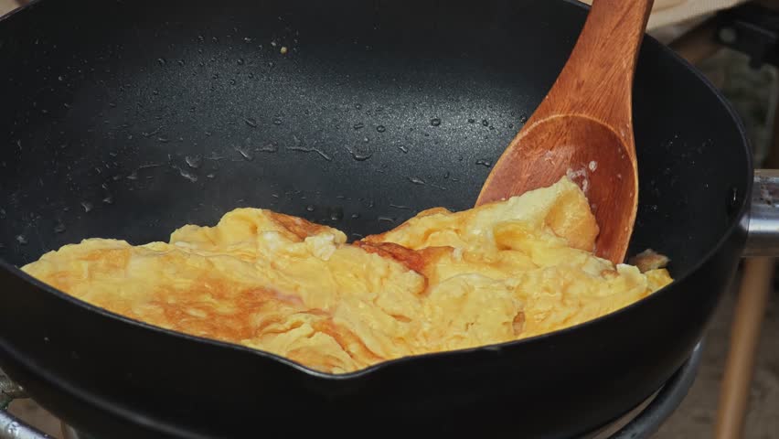 fried omlet in black pan