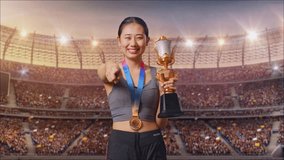 Asian Woman With A Gold Medal And Trophy Touching Her Chest Then Smiling And Pointing To Camera Being Proud Of Herself At The Stadium - Powered by Shutterstock - Get 15% off with code: PIKWIZARD15