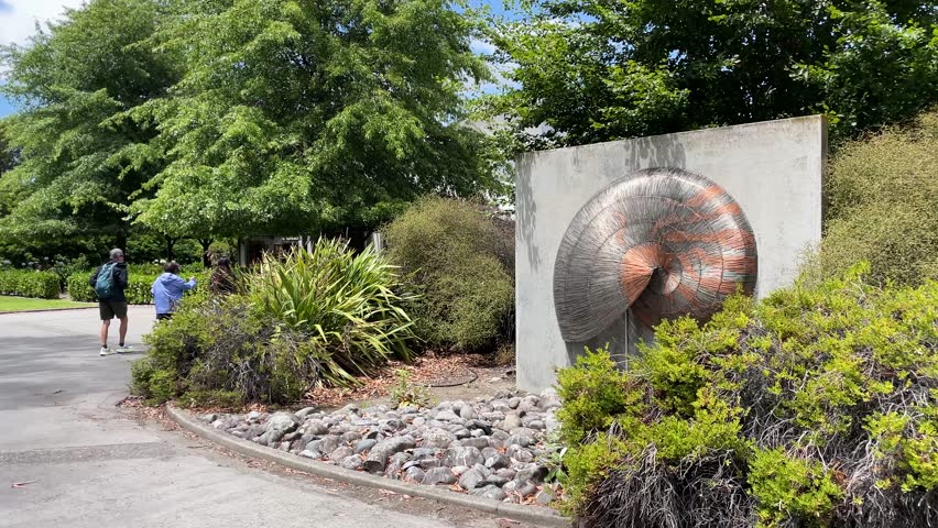 Renwick , New Zealand - 02 26 2025: Nautilus Estate sculpture in outdoor garden setting, surrounded by trees and greenery