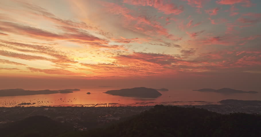 aerial view sunrise over the mountain. landscape with sun over the sea.
Horizon panorama mountain and dramatic sky and cloud sunrise background.
Nature video High quality footage.
Chalong gulf.