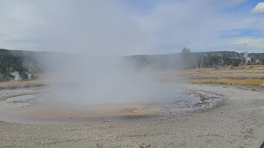 Water and steam is erupting from Geyser. Close up view.  Yellowstone National Park, Wyoming, United States