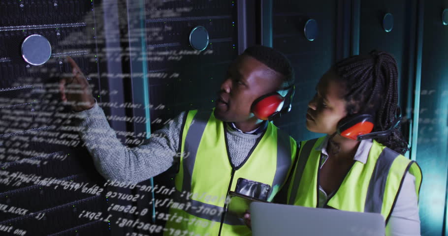 In server room, technicians in safety vests discussing animation data processing. Technology, data center, teamwork, discussion, networking, IT