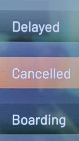 International Airport Terminal: Arrival and Departure Monitor Showing Flight Information, Status of Flights for Travelers. Digital Timetable Board For Passengers with Planes Schedule. Vertical Shot.