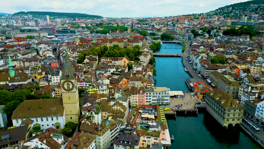 4K Drone Video of the Historic Grossmünster, Fraumünster, Predigerkirche, and St. Peter Churches on the banks of the Limmat River in Downtown Zurich, Switzerland